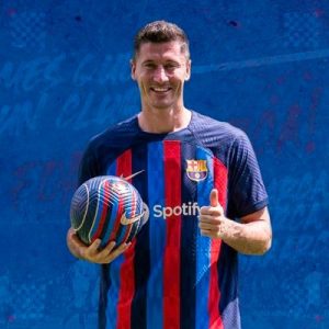 Robert Lewandowski with a football in his hand and in Barcelona jersey